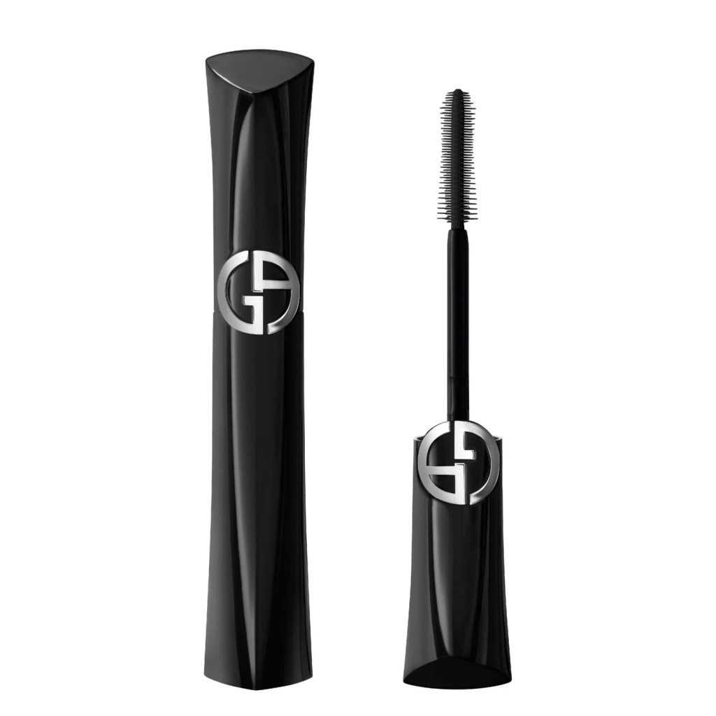 A black mascara tube with a sleek design and the logo on the front, next to a mascara wand with fine bristles.