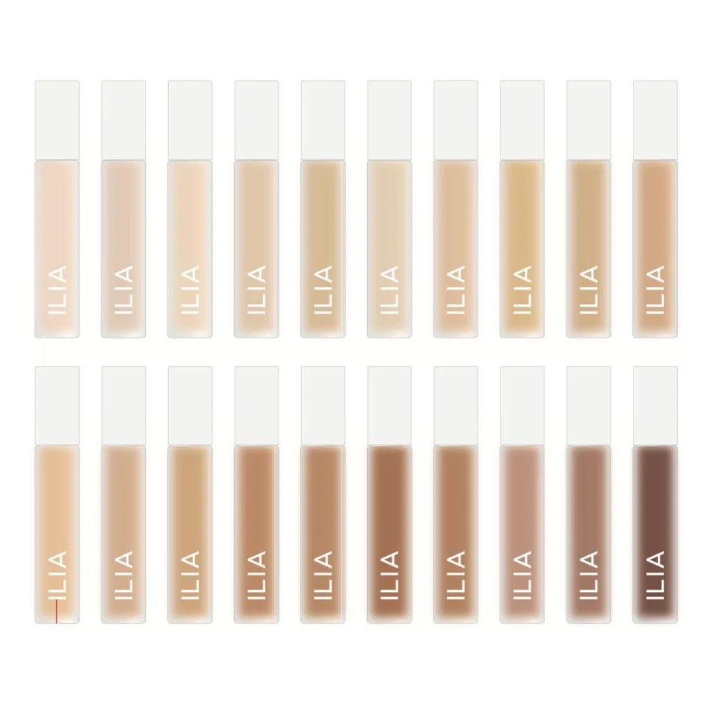 A grid of 18 cosmetic tubes labeled ILIA, showcasing different shades of foundation or concealer.