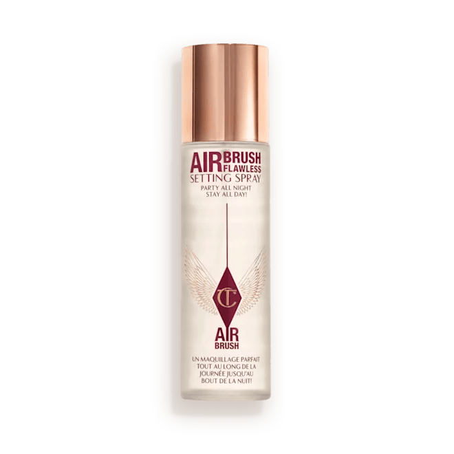Airbrush Flawless Setting Spray bottle with a rose gold cap, labeled 'Party All Night! Stay All Day!'