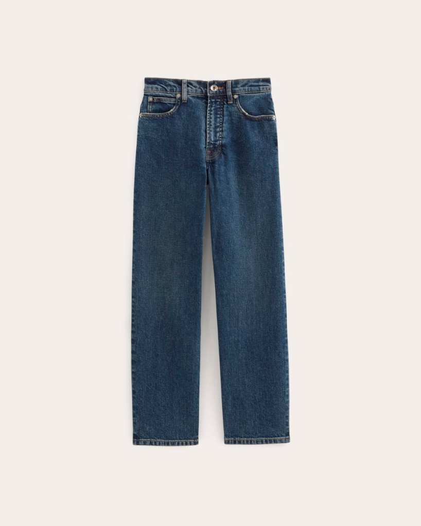 A pair of blue high-waisted denim jeans displayed against a light background.