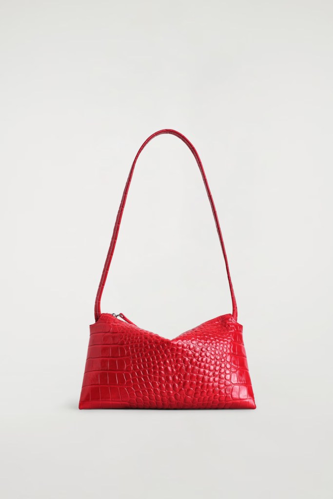Red crocodile-embossed handbag with a curved design and a single shoulder strap