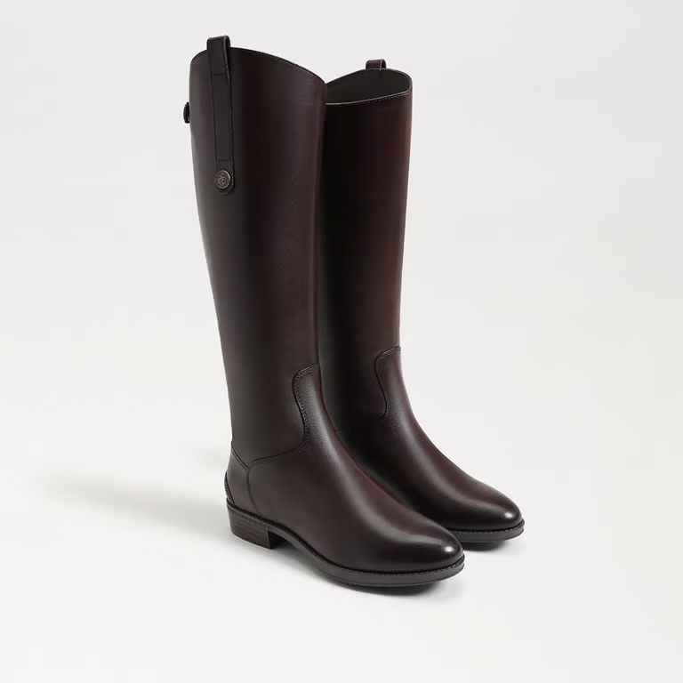 A pair of stylish, tall brown leather boots with a sleek design and a low heel.