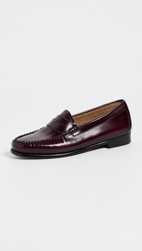 Burgundy leather loafers featuring a stitched detailing and a low heel.