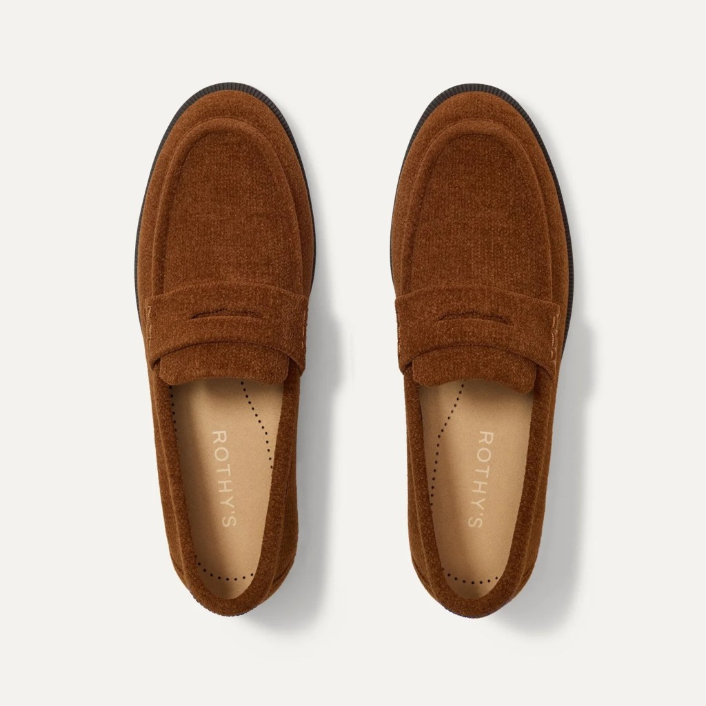 A pair of brown loafers with a textured fabric upper and a simple design, labeled with 'ROTHY'S' on the insoles.