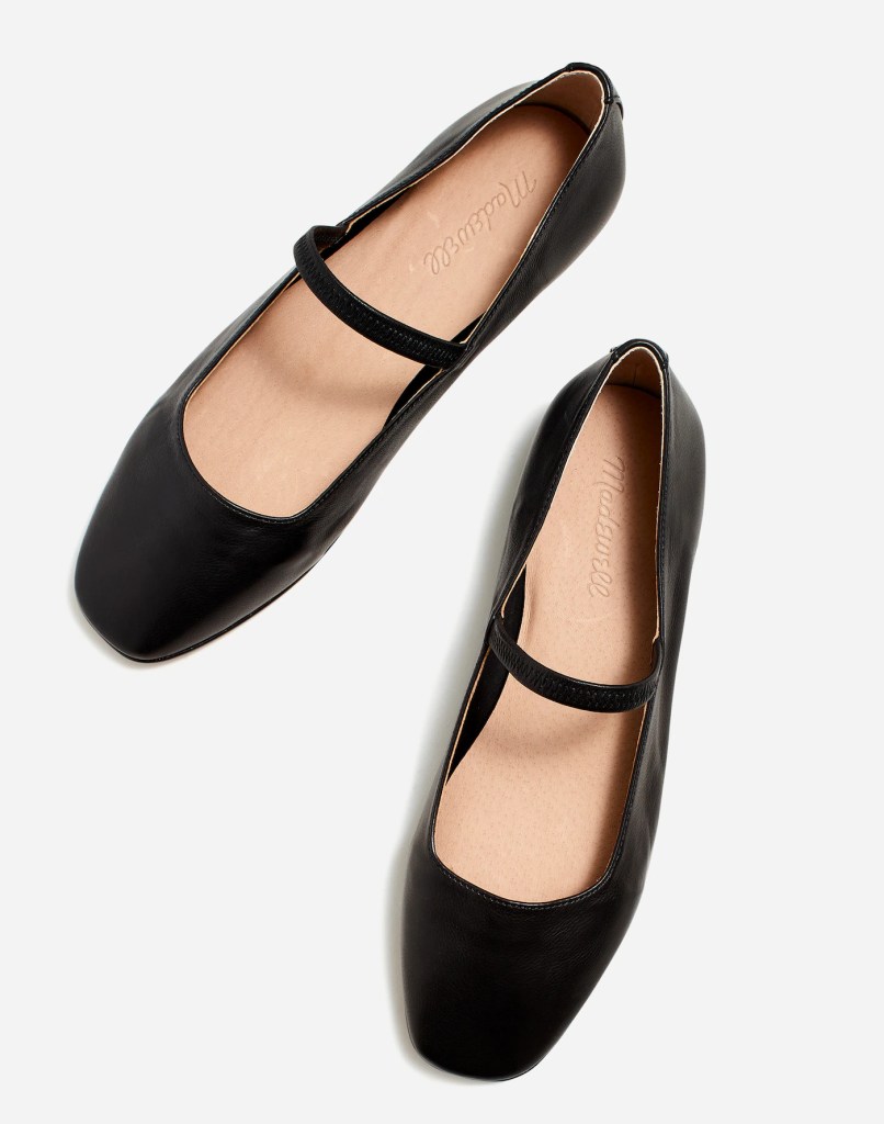 A pair of black leather ballet flats with a Mary Jane strap.
